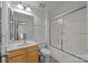 Well-lit bathroom with a shower and bathtub combination, vanity, and neutral tile flooring at 7262 April Mist Trl, Huntersville, NC 28078
