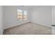 Bedroom with double window for natural light and neutral carpeted floors at 7262 April Mist Trl, Huntersville, NC 28078