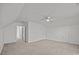Spacious bonus room under a vaulted ceiling, with neutral carpet, and a ceiling fan at 7262 April Mist Trl, Huntersville, NC 28078
