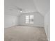 Spacious bonus room under a vaulted ceiling, with neutral carpet, and a ceiling fan at 7262 April Mist Trl, Huntersville, NC 28078
