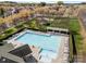 Aerial of community pool with seating and amenities, surrounded by lush landscaping and greenery at 7262 April Mist Trl, Huntersville, NC 28078