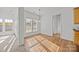 Bright dining area with wood floors and natural light, adjacent to the kitchen at 7262 April Mist Trl, Huntersville, NC 28078