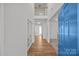 Bright, inviting entryway with hardwood floors and view to the upper floor landing at 7262 April Mist Trl, Huntersville, NC 28078