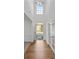 Inviting entryway featuring hardwood floors, a large window, and decorative trim at 7262 April Mist Trl, Huntersville, NC 28078