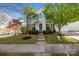 Charming two-story home with a well-manicured lawn, inviting walkway, and vibrant landscaping at 7262 April Mist Trl, Huntersville, NC 28078
