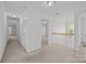 Upstairs hallway with hardwood railing and doors leading to bedrooms at 7262 April Mist Trl, Huntersville, NC 28078