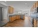 Well-equipped kitchen with wood cabinets, stainless steel appliances, and laminate floors at 7262 April Mist Trl, Huntersville, NC 28078