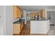 Bright kitchen features wood cabinets, dark countertops, stainless steel appliances, and hardwood flooring at 7262 April Mist Trl, Huntersville, NC 28078