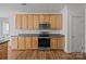 Kitchen view showcases wood cabinets, dark countertops, and stainless steel appliances at 7262 April Mist Trl, Huntersville, NC 28078