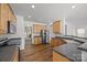 Bright kitchen showcases wood cabinets, dark countertops, stainless steel appliances, and hardwood flooring at 7262 April Mist Trl, Huntersville, NC 28078