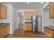 Kitchen features wood cabinets, dark countertops, stainless steel appliances, and hardwood flooring at 7262 April Mist Trl, Huntersville, NC 28078