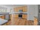 Kitchen with wood cabinets, dark countertops, stainless steel appliances, and hardwood flooring at 7262 April Mist Trl, Huntersville, NC 28078