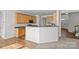 Open-concept kitchen with breakfast bar and view to dining area and stairs at 7262 April Mist Trl, Huntersville, NC 28078