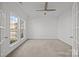 Spacious office with neutral carpet, ceiling fan, and bright natural light from two windows at 7262 April Mist Trl, Huntersville, NC 28078