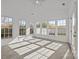 Light-filled sunroom with vaulted ceiling and multiple windows offering backyard views at 7262 April Mist Trl, Huntersville, NC 28078