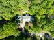 Aerial view of a cozy home surrounded by a lush canopy of trees, showcasing privacy and natural beauty at 7624 Cedarbrook Dr, Charlotte, NC 28215