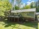 Charming backyard features a spacious deck, perfect for relaxing and enjoying the serene outdoor setting at 7624 Cedarbrook Dr, Charlotte, NC 28215