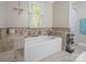 Relaxing bathroom with a built-in tub and tiled surround at 7624 Cedarbrook Dr, Charlotte, NC 28215
