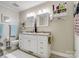 Well-lit bathroom with a double sink vanity and stylish decor at 7624 Cedarbrook Dr, Charlotte, NC 28215