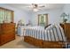Bright bedroom with hardwood floors, natural light, and a comfortable bed at 7624 Cedarbrook Dr, Charlotte, NC 28215