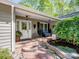 Inviting front porch features a seating area, attractive brickwork, and well-maintained landscaping at 7624 Cedarbrook Dr, Charlotte, NC 28215