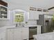 Bright kitchen featuring stainless steel appliances and a sink with a view to outside at 7624 Cedarbrook Dr, Charlotte, NC 28215