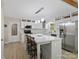 Bright, open kitchen with a large center island, stainless steel appliances, and white cabinetry at 7624 Cedarbrook Dr, Charlotte, NC 28215