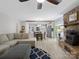 Spacious living room connects to the kitchen, featuring a stone fireplace and wood floors at 7624 Cedarbrook Dr, Charlotte, NC 28215