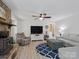 The living room includes a stone fireplace, comfortable seating, and a stylish ceiling fan at 7624 Cedarbrook Dr, Charlotte, NC 28215