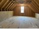 Unfinished attic space with exposed beams and a window at 906 Wisteria Way, Salisbury, NC 28146