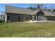 Spacious backyard featuring a covered patio and lush green grass at 906 Wisteria Way, Salisbury, NC 28146