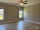 Spacious bedroom with wood floors, a ceiling fan, and two large windows at 906 Wisteria Way, Salisbury, NC 28146