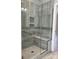 Modern walk-in shower featuring stylish tile, a built-in seat, and glass door at 906 Wisteria Way, Salisbury, NC 28146