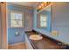 Bathroom with single sink vanity and a bright window with natural light at 100 W 3Rd St, Cherryville, NC 28021