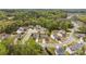 Aerial view of a residential area showcases well-maintained homes amidst lush greenery and trees at 10773 Sapphire Trl, Davidson, NC 28036