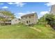 Spacious backyard with lush lawn, patio, and wooded backdrop, perfect for outdoor entertaining at 10773 Sapphire Trl, Davidson, NC 28036