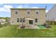 Well-maintained backyard featuring a patio area with an umbrella and a small putting green for leisure at 10773 Sapphire Trl, Davidson, NC 28036