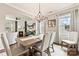 Sunlit dining room with stylish furnishings, an elegant chandelier, and an archway leading to the cozy living room at 10773 Sapphire Trl, Davidson, NC 28036