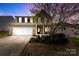 Charming two-story brick home with a well-manicured lawn and attached two-car garage at 10773 Sapphire Trl, Davidson, NC 28036