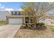 Charming two-story brick home with a well-manicured lawn and attached two-car garage at 10773 Sapphire Trl, Davidson, NC 28036