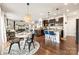 Inviting kitchen with granite countertops, stainless appliances, and adjacent breakfast nook with modern pendant lighting at 10773 Sapphire Trl, Davidson, NC 28036