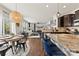 Open-concept living area with a kitchen island, dining table, and cozy living room with fireplace at 10773 Sapphire Trl, Davidson, NC 28036