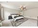 Spacious main bedroom with a ceiling fan, plush carpet, a comfortable bed, and a tranquil, inviting atmosphere at 10773 Sapphire Trl, Davidson, NC 28036