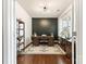 Bright office space with unique accent wall, hardwood floors, and ample natural light from a large window at 10773 Sapphire Trl, Davidson, NC 28036