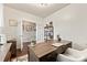 Well-appointed office space with dark wood desk, cozy armchair, and ample storage, perfect for a productive workspace at 10773 Sapphire Trl, Davidson, NC 28036