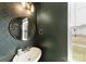 Stylish powder room features modern wallpaper, a mirror, and a window with natural light at 10773 Sapphire Trl, Davidson, NC 28036