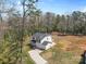 Expansive aerial view of home nestled in a wooded area, featuring a large yard and driveway at 109 Landon Ct, Shelby, NC 28152