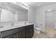 Modern bathroom featuring double sinks and wood-look flooring at 109 Landon Ct, Shelby, NC 28152