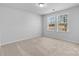 Serene bedroom space with neutral walls, plush carpeting, and multiple windows offering natural light at 109 Landon Ct, Shelby, NC 28152