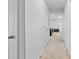 Bright hallway with neutral carpet, white walls, and multiple doors leading to various rooms at 109 Landon Ct, Shelby, NC 28152